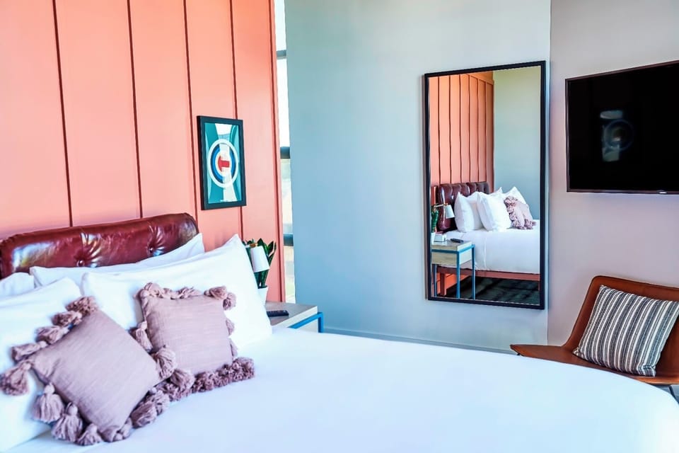 Unwind with fluffy pillows, warm textures, and in-room entertainment.