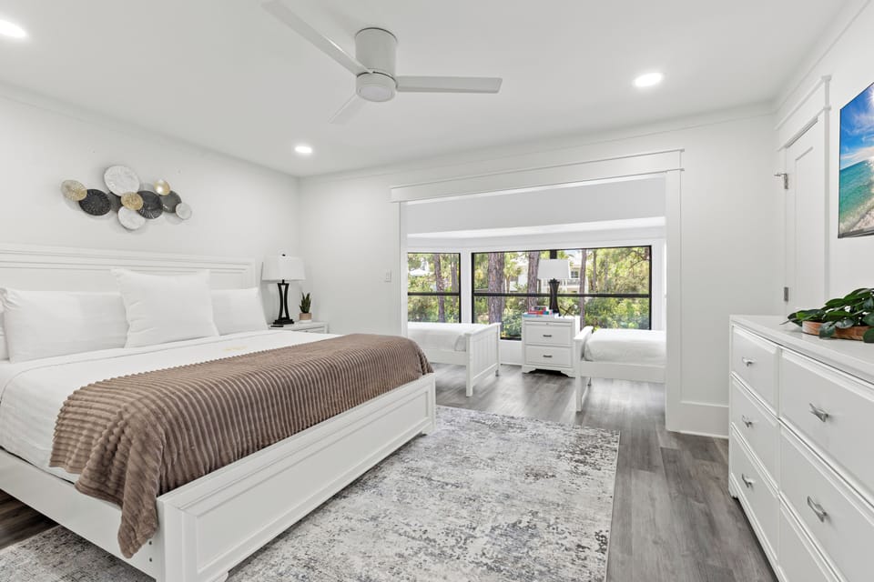 Unwind in your serene bedroom sanctuary with plush bedding, natural light streaming through large windows, and modern amenities for ultimate comfort.