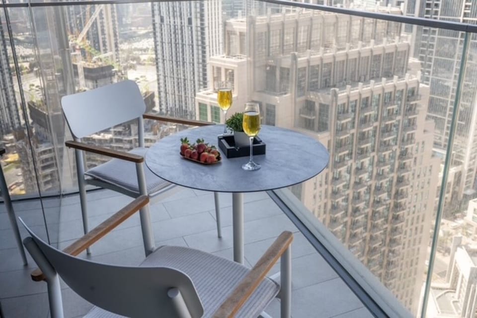 outdoor furniture on balcony overlooking the city and ocean 