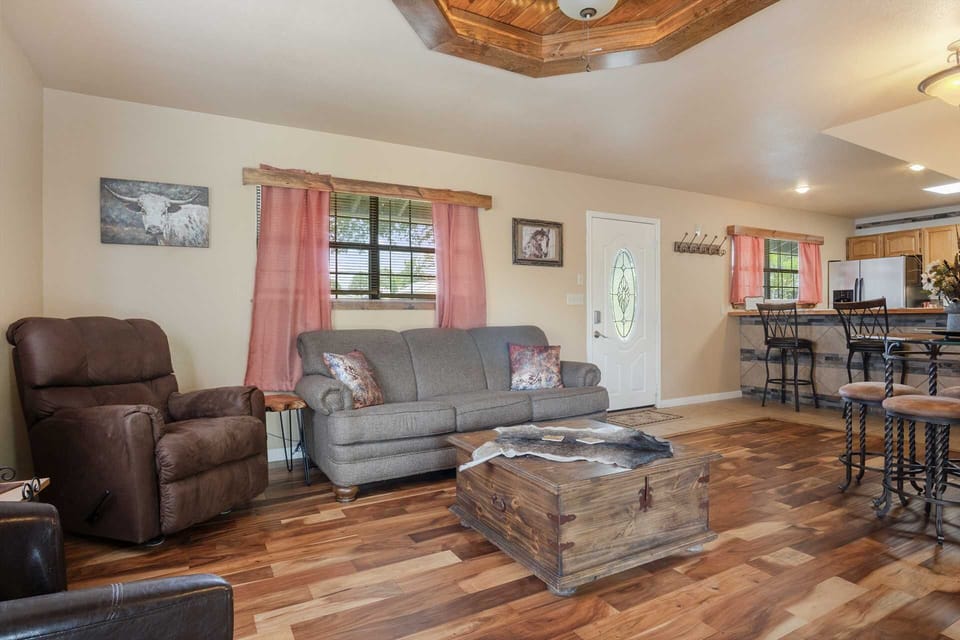 Open living space with cozy seating, rustic accents, and a seamless flow into the kitchen.