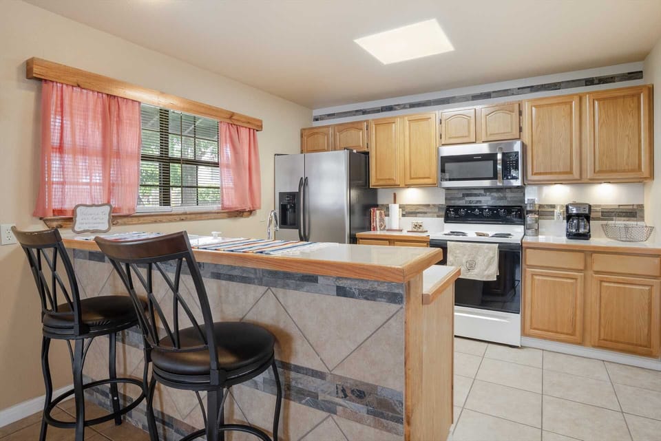 Whip up your favorite meals in our fully equipped kitchen! Featuring modern appliances, ample counter space, and a cozy breakfast bar, it's perfect for preparing delicious dishes during your vacation. Start planning your culinary adventures with us!