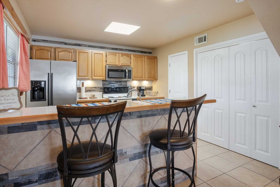 Gather around our inviting kitchen, the heart of your vacation rental! With a spacious breakfast bar and easy access to all the essentials, it's perfect for cooking, dining, and making memories. Book your stay and enjoy home-cooked meals away from home!