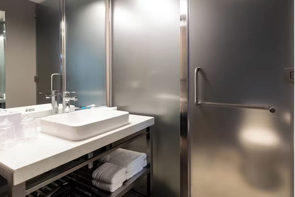 Pamper yourself with plush towels and a sleek rainfall shower.