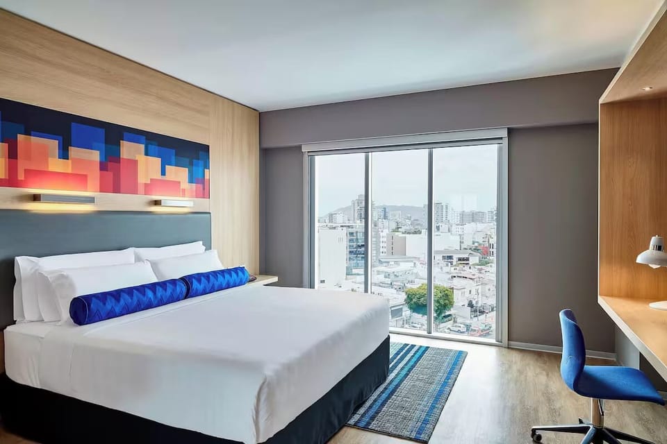 Wake up refreshed beside floor-to-ceiling windows and skyline views.