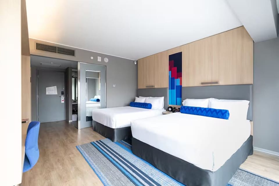 Settle into spacious comfort with two plush beds and airy design.