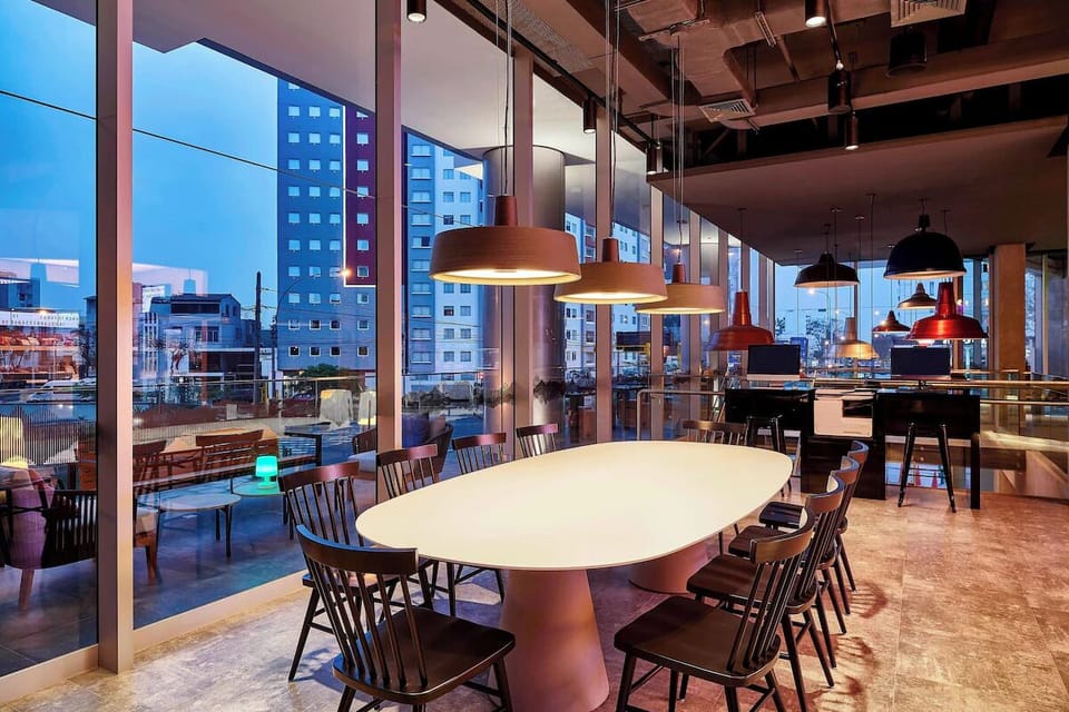 Gather for cocktails around a glowing table with skyline views.