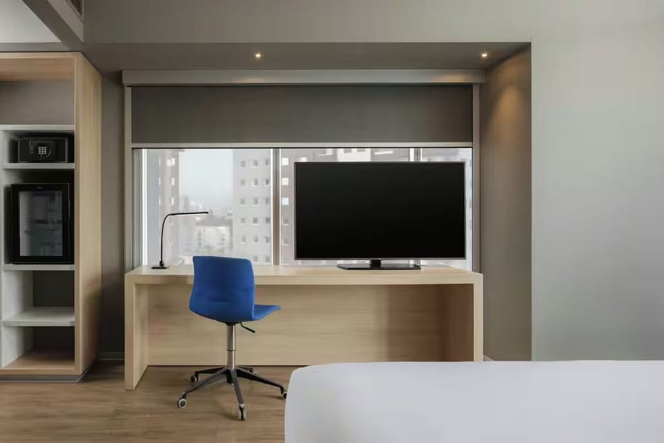 Work comfortably at the window desk with a large TV.