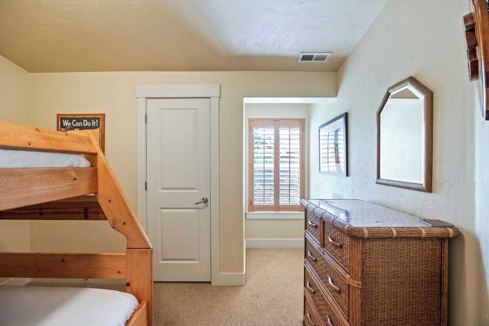 - Bunk bedroom with twin-over-full bed for flexible sleeping  
- Bright window with shutters and cozy carpet flooring  
- Perfect space for kids, friends, or family group stays