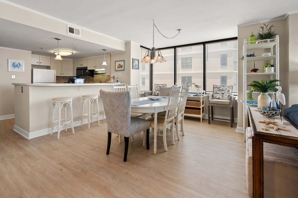 Open-plan living, dining and kitchen space with a breakfast bar at Sea Pointe 702, a Cherry Grove condo rental
