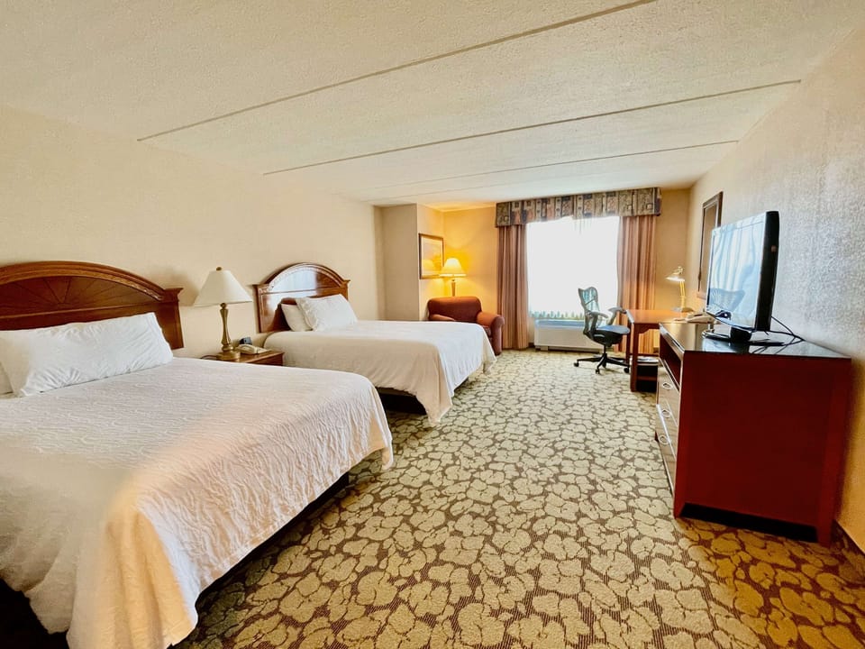 Wake up to soft daylight in your airy double-queen retreat.