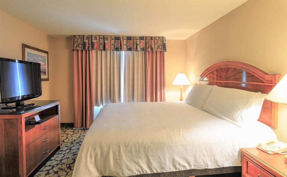 Sink into a plush king bed under warm bedside glow.