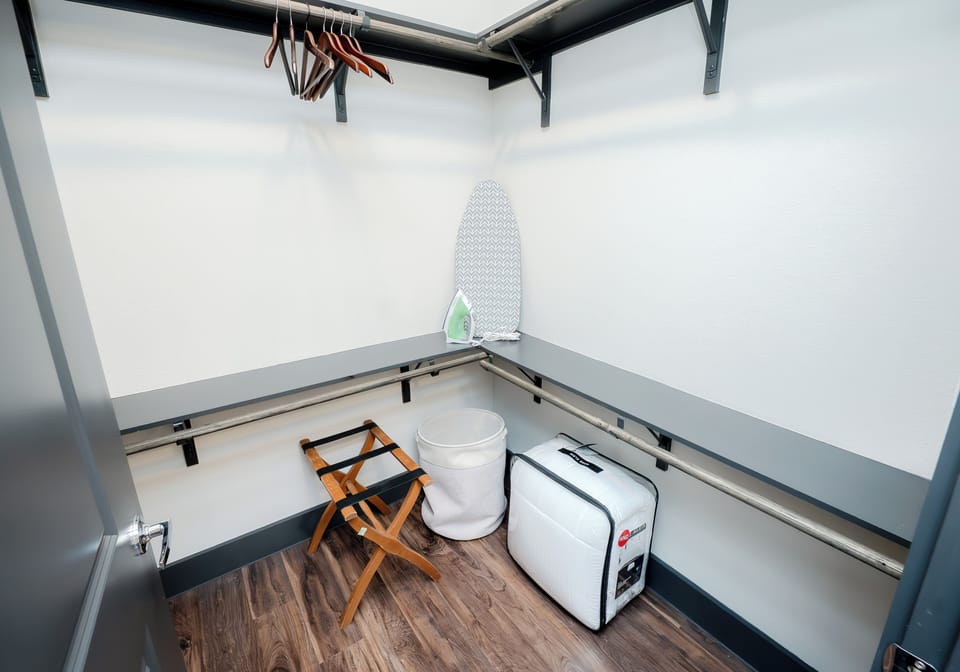 Walk in closet with hangers and extra comforter 