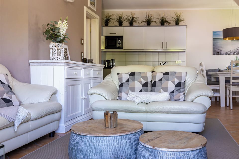 Cozy Living Room with Leather Sofas and Wooden Tables