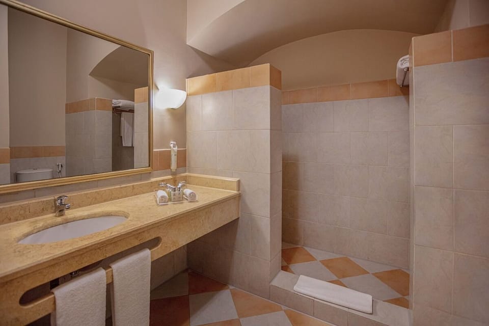 Refresh in a spotless bath with deep vanity and walk-in shower.
