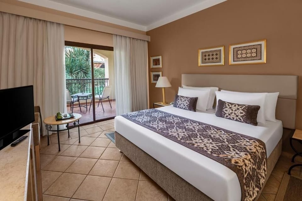 Wake up refreshed in a king bed with balcony breeze.