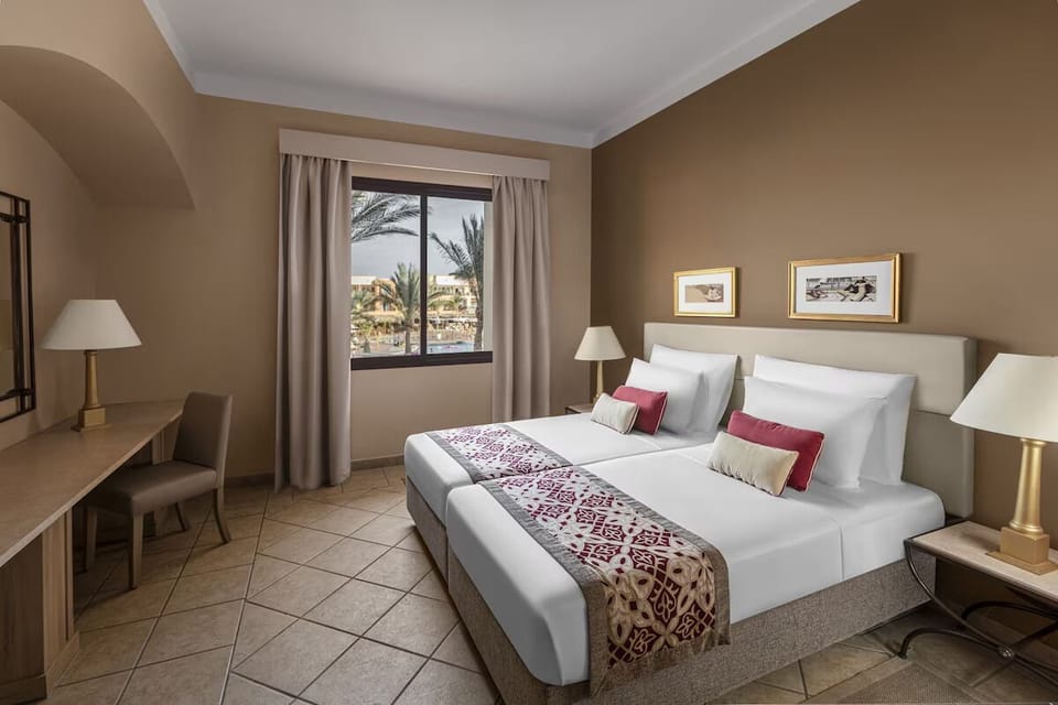 Recharge in a calm room with desk and restful beds.
