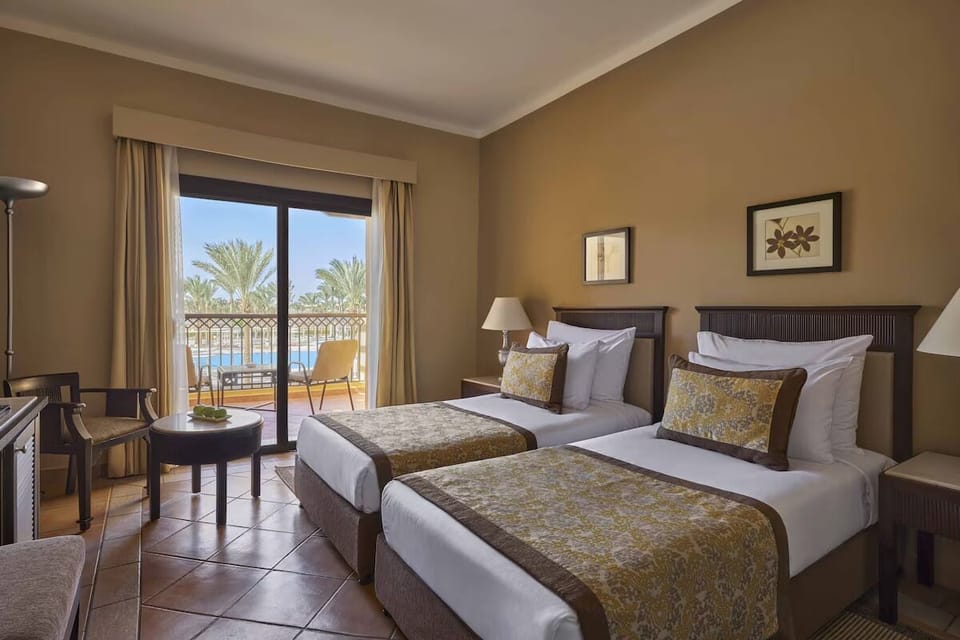 Unwind in crisp twin beds with breezy balcony views.
