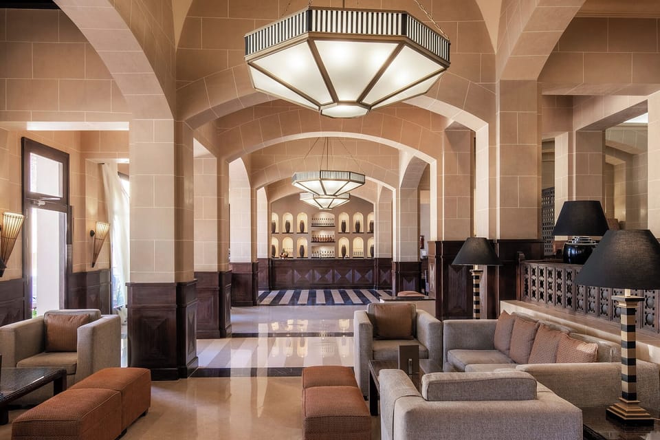 Unwind beneath grand arches in a serene, airy lounge.