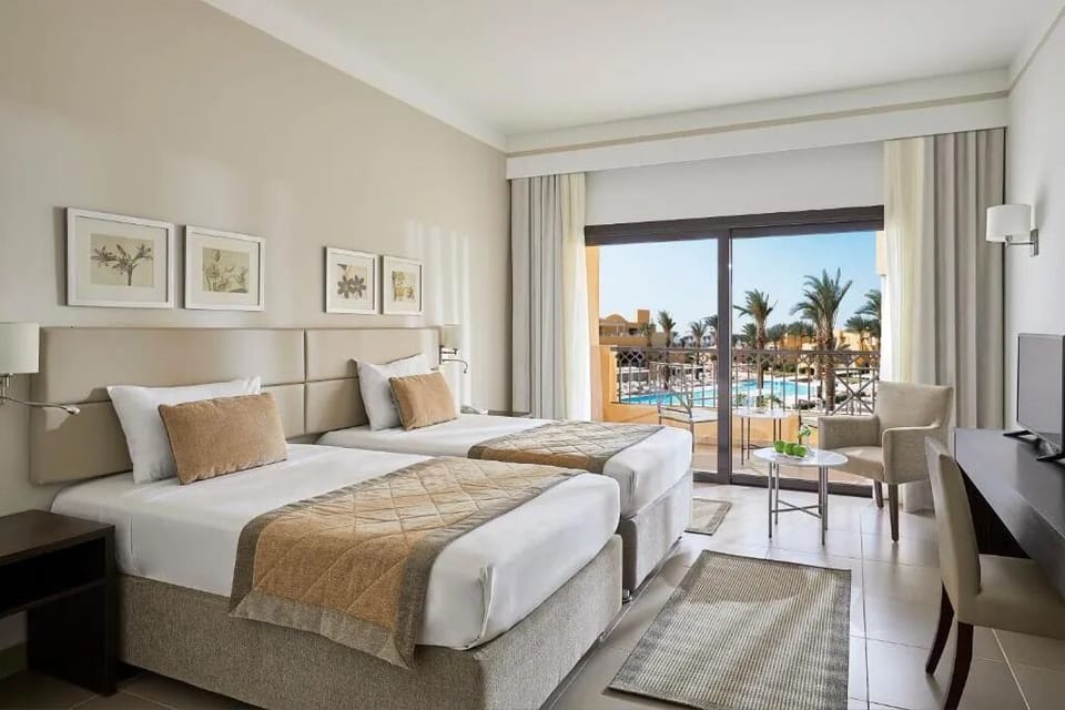 Wake up to pool views from serene twin beds.