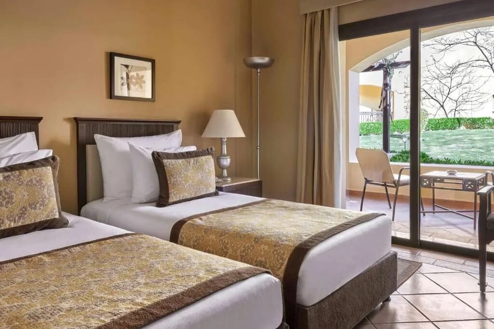 Unwind in twin beds after sunny balcony adventures.
