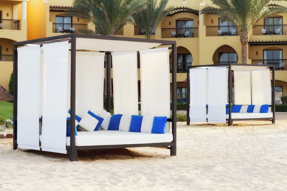 Unwind on shaded daybeds with breezy beachside comfort.