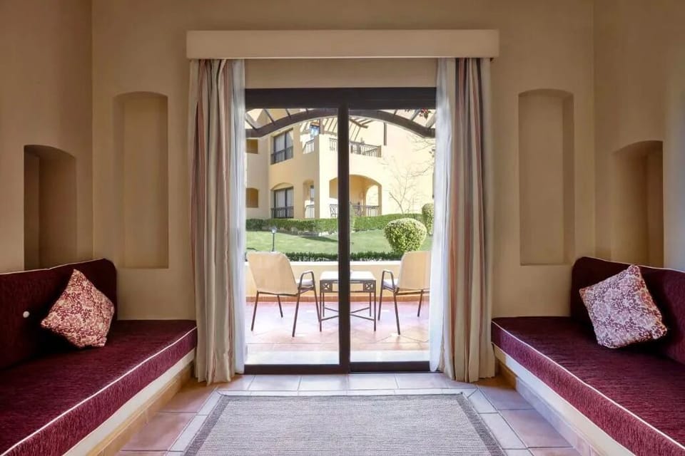 Lounge on built-in daybeds as sunlight pours through glass doors.