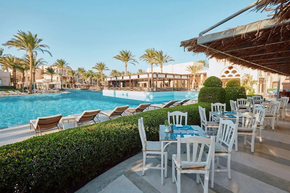 Sip and unwind at shaded tables steps from the refreshing pool.