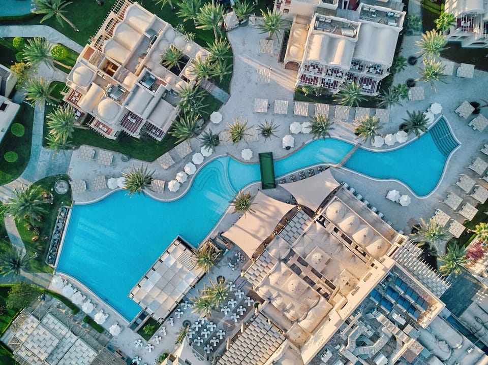 Soak up sunshine beside the lagoon-style pool and palms.