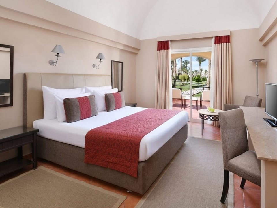 Unwind in crisp linens with garden-view balcony breeze.