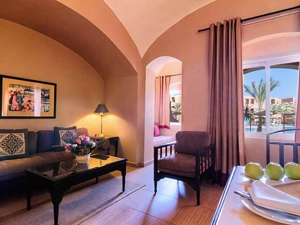 Enjoy the spacious suite layout with lounge seating and TV.