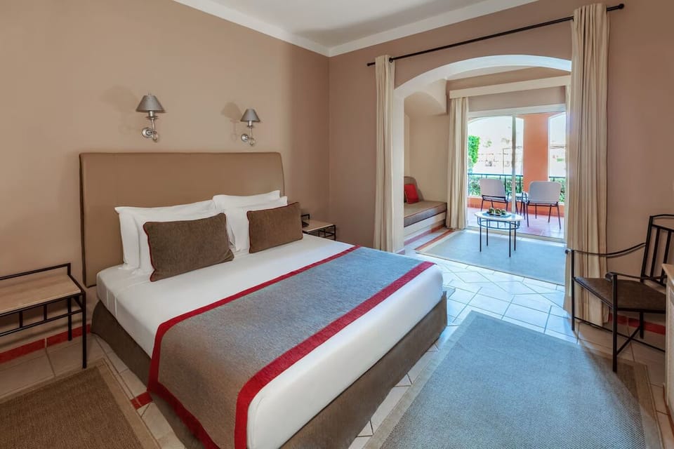 Wake up to soft light and a private balcony escape.