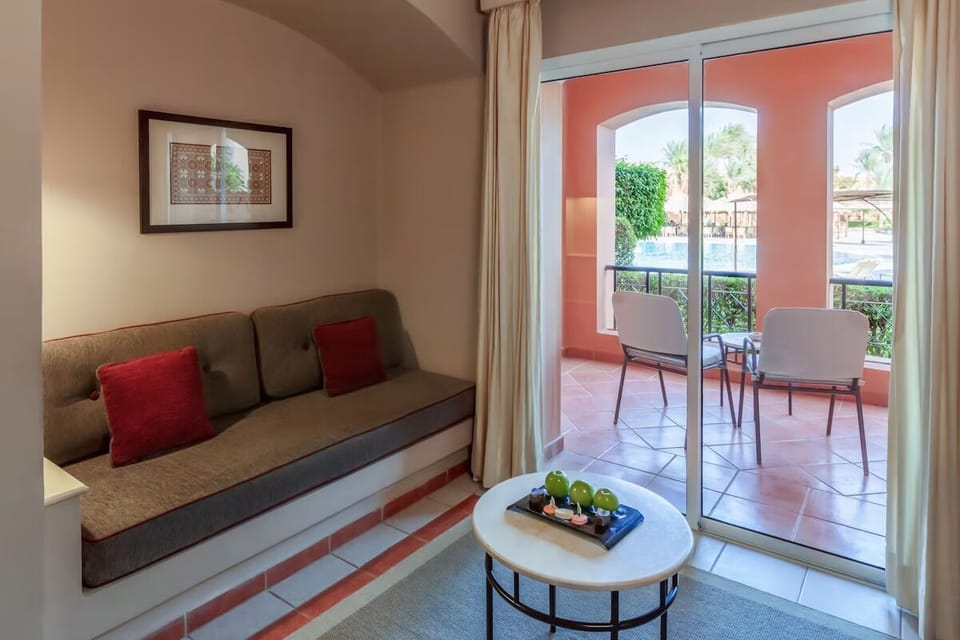 Unwind by the bright terrace doorway with cozy seating.