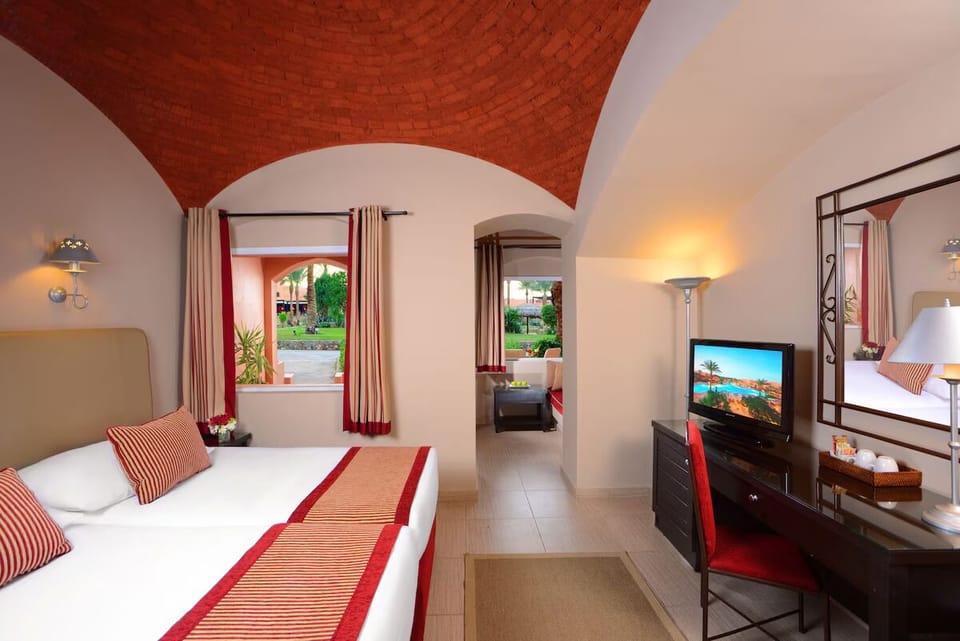 Relax in a bright bedroom with elegant arched architecture.