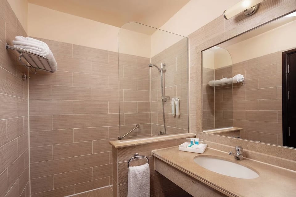Refresh after adventures in a spotless bath with rain-style shower.