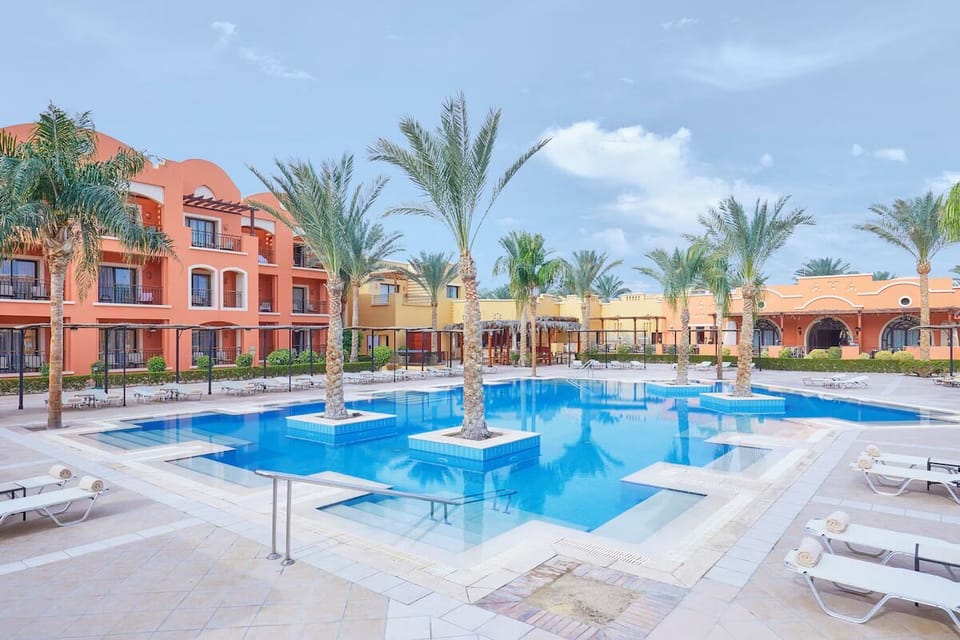 Dive into sunlit calm beside palms and sparkling water.