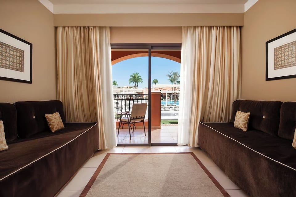 Relax on deep sofas facing the balcony for evening downtime.
