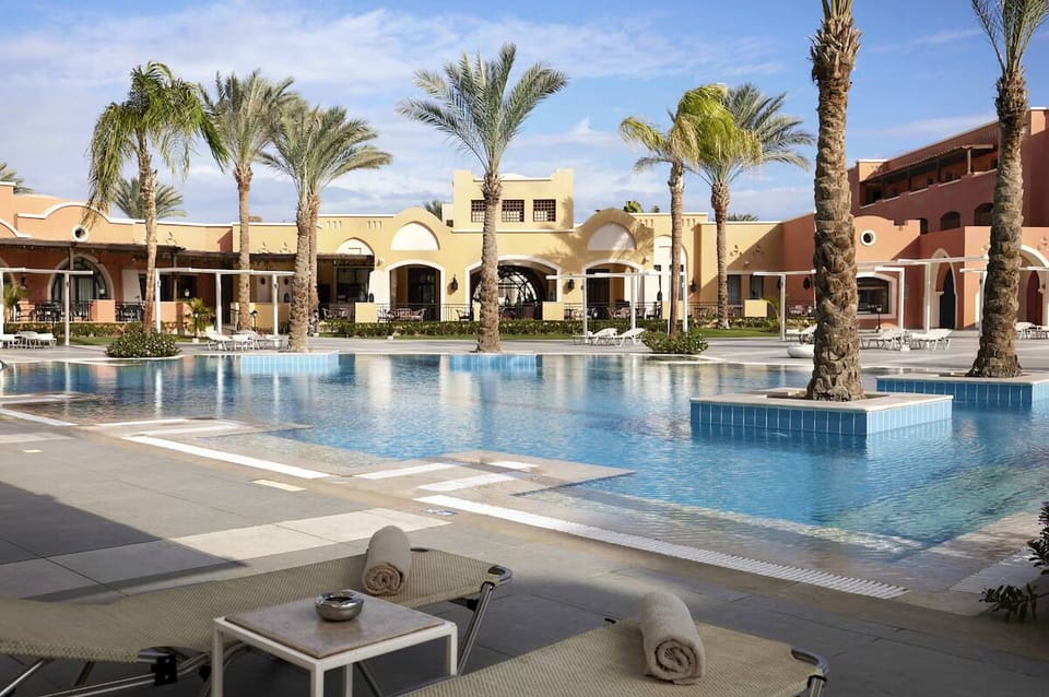 Unwind on cushioned loungers steps from the cool pool.