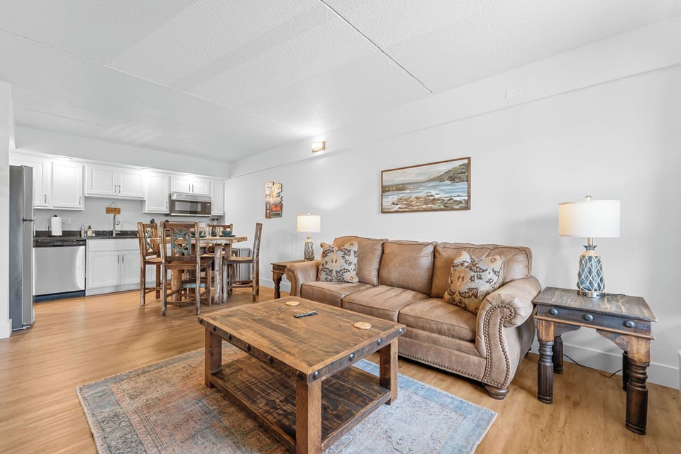 Open floor plan includes a living area with a sleeper sofa, streaming-capable TV, various board games, a fully equipped kitchen, a bedroom, and a bathroom, Creek View.