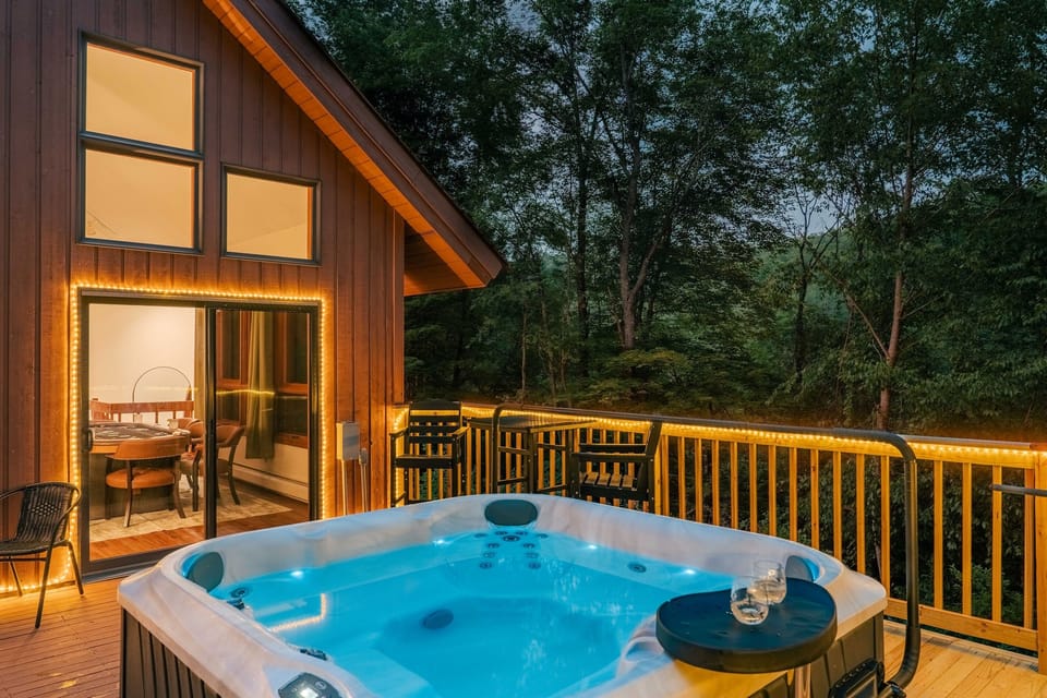 Soak under the stars in your private hot tub—surrounded by forest views and twinkling lights for a truly serene escape.