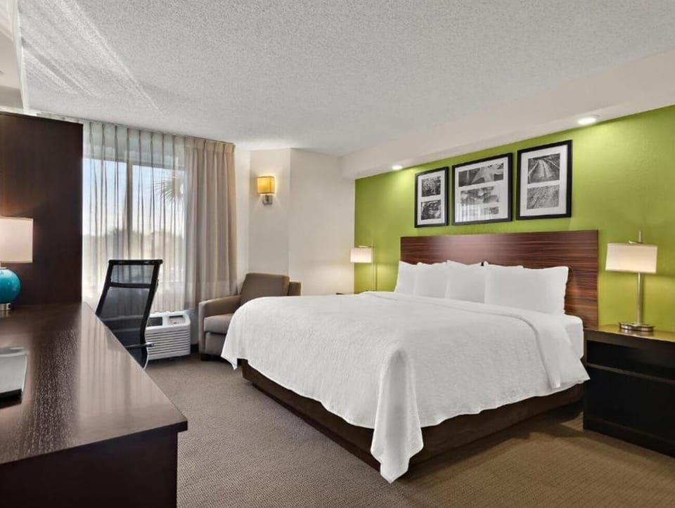 Unwind in a plush king bed with sunny city light.