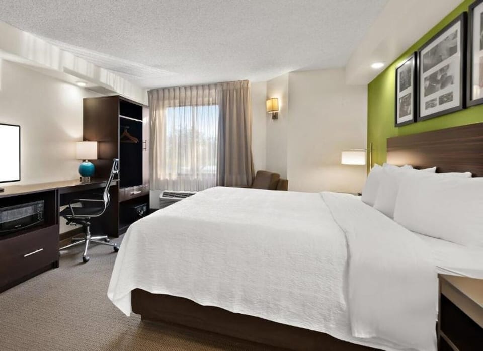 Recharge in a serene king room with work-friendly comforts.