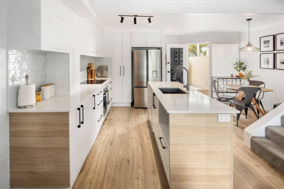 The kitchen combines style with functionality, featuring sleek cabinetry and thoughtful touches like a dishwasher, oven, and full-size fridge.