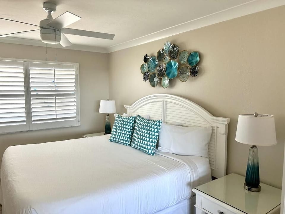 Wake up refreshed in a serene, coastal-styled bedroom