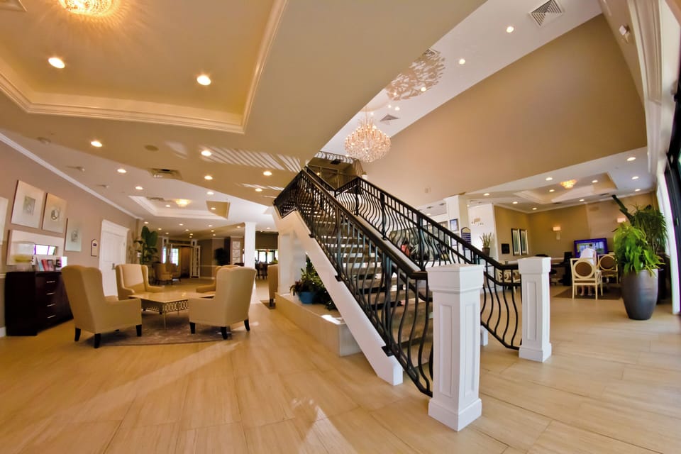 Arrive in style beneath sparkling chandeliers and airy staircases.
