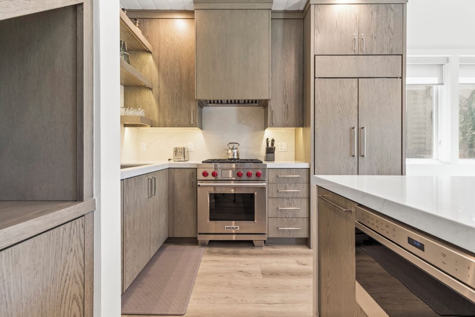 The well equipped kitchen with gas range and hidden refrigerator.