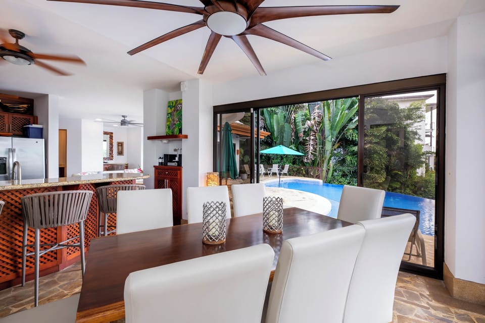 Elegant dining space overlooking the infinity pool and tropical canopy.