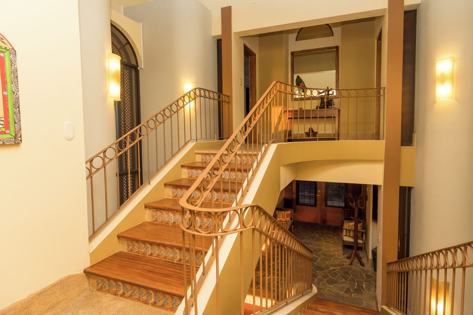 Elegant wood staircase connecting the villa's open living spaces