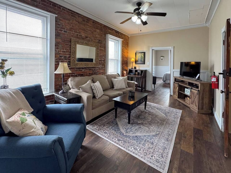 Another view of the inviting living room, highlighting the rug and coffee table.