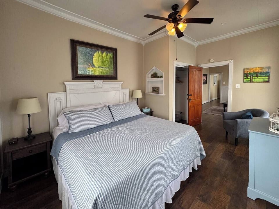 Comfortable bedroom with a large bed and a glimpse into the attached bathroom.