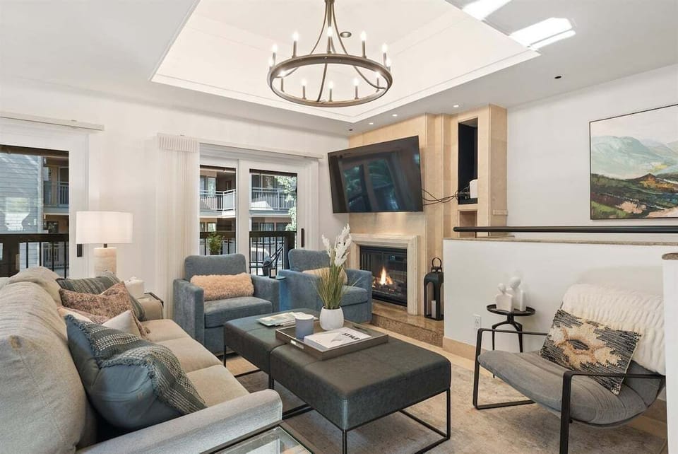 Main floor featuring an open concept kitchen, living, and dining area with wood-burning fireplace and private porch.